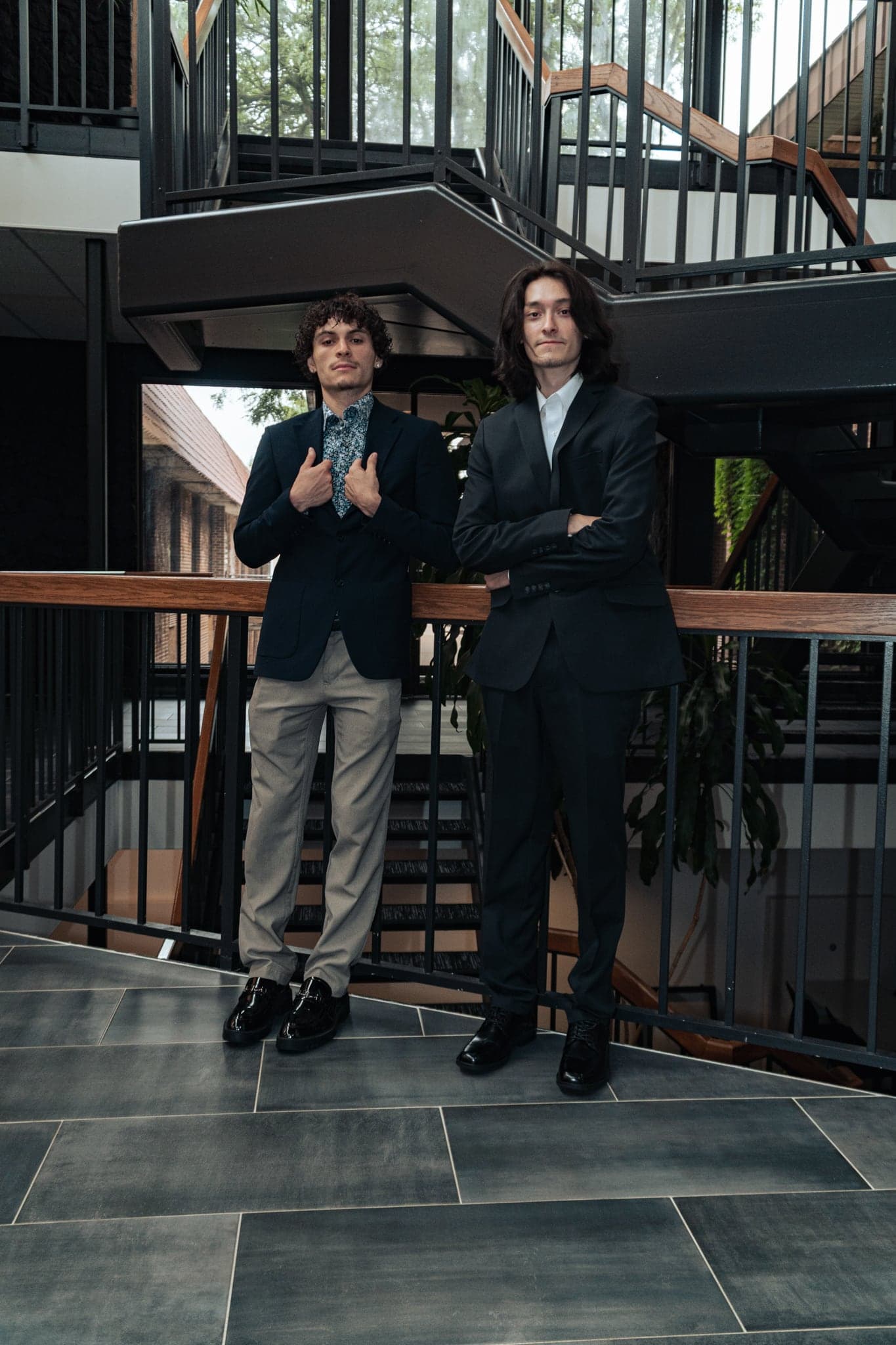 Two friends photographed together on a staircase