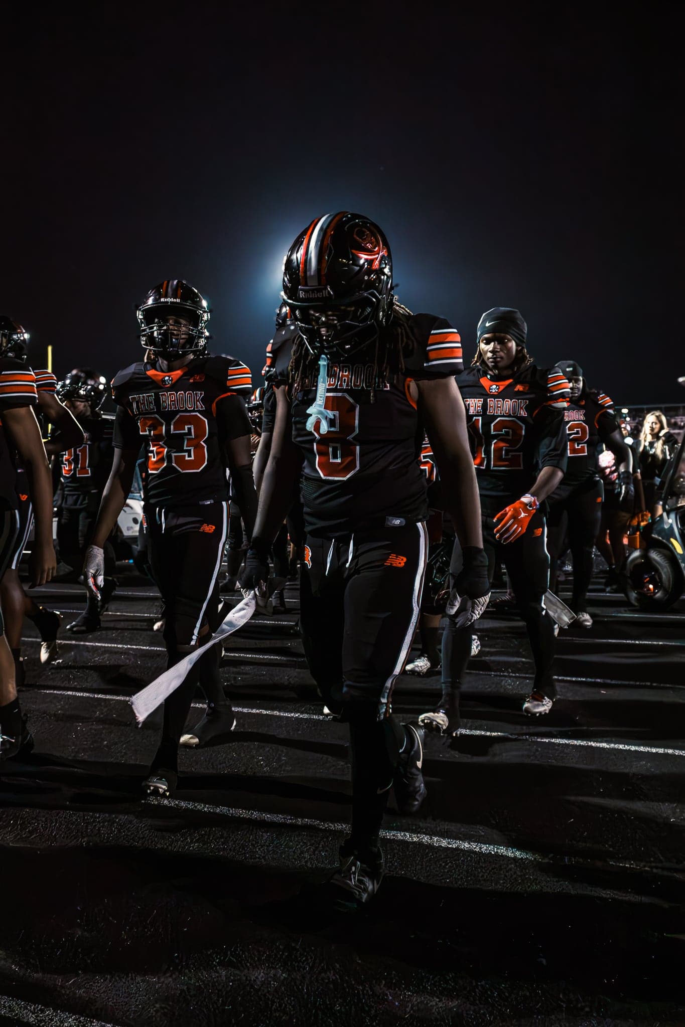 A team walking out together under the lights