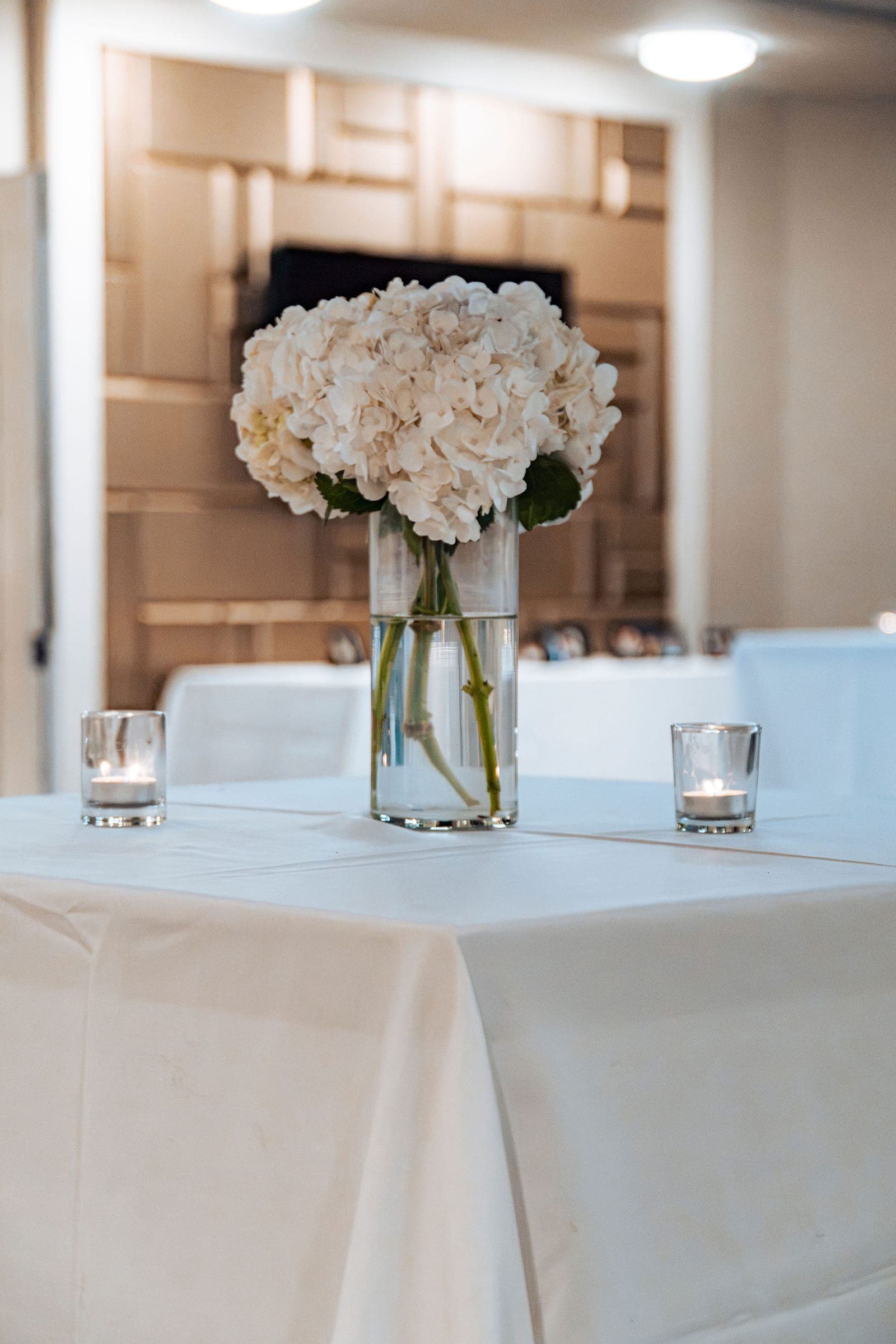 White hydrangeas on a candlelit reception table