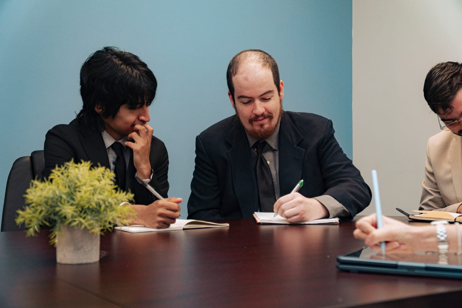Colleagues taking notes together during a meeting