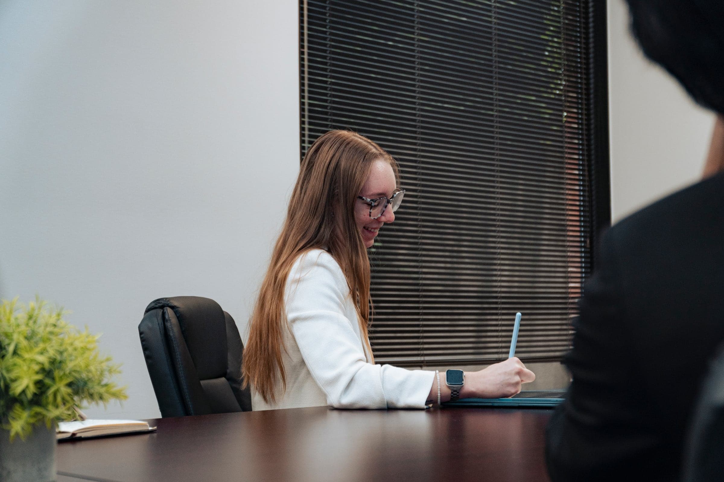 A team member working at her desk in natural light