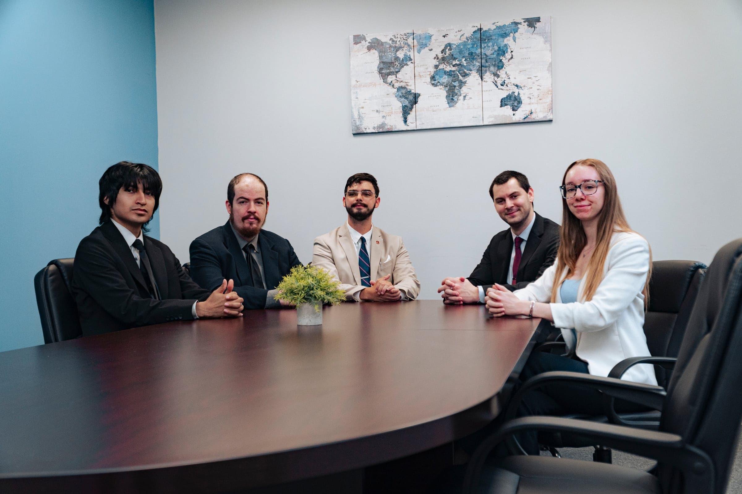 A company leadership team gathered around the boardroom table