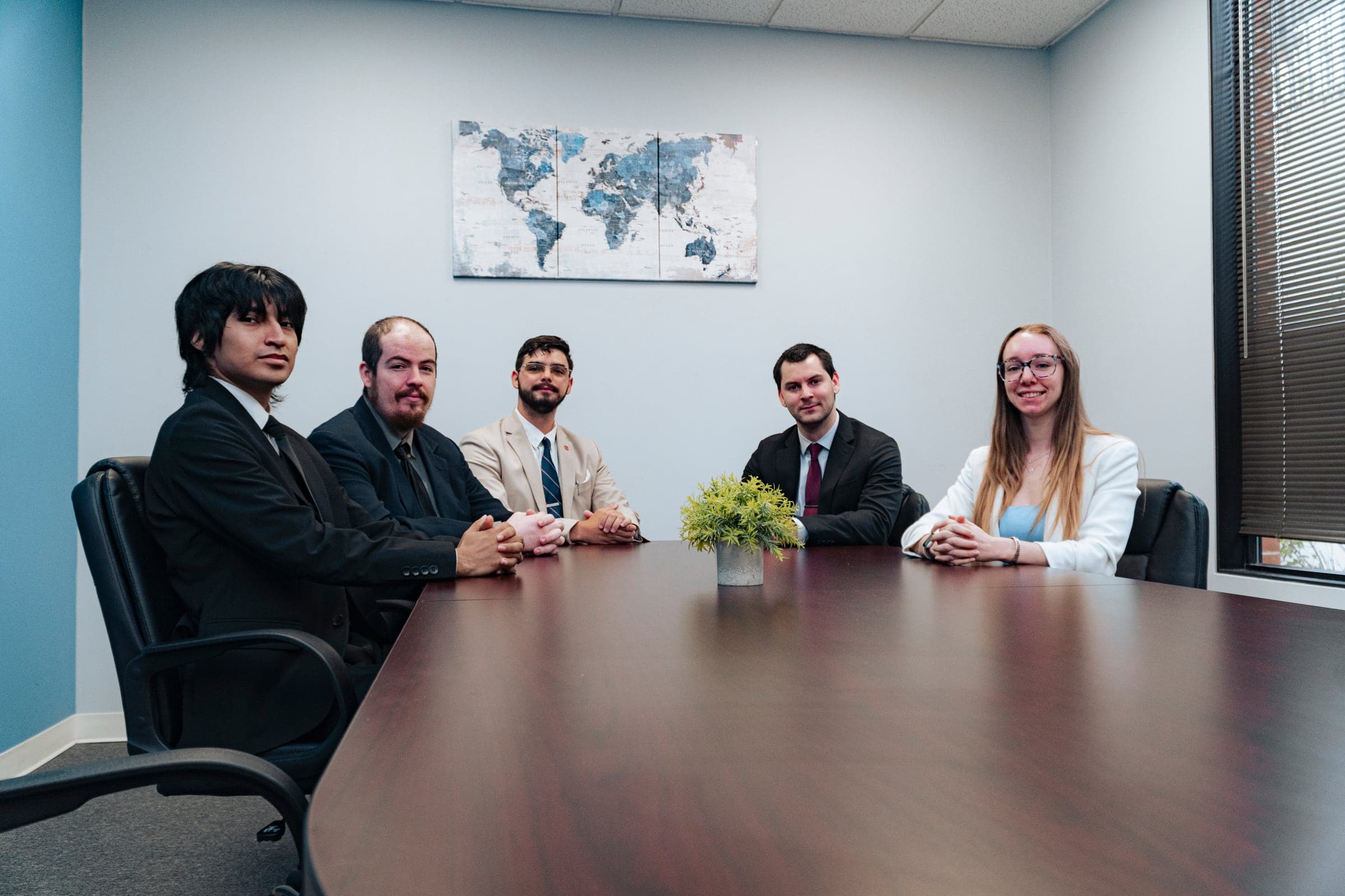 A full team seated around the boardroom table