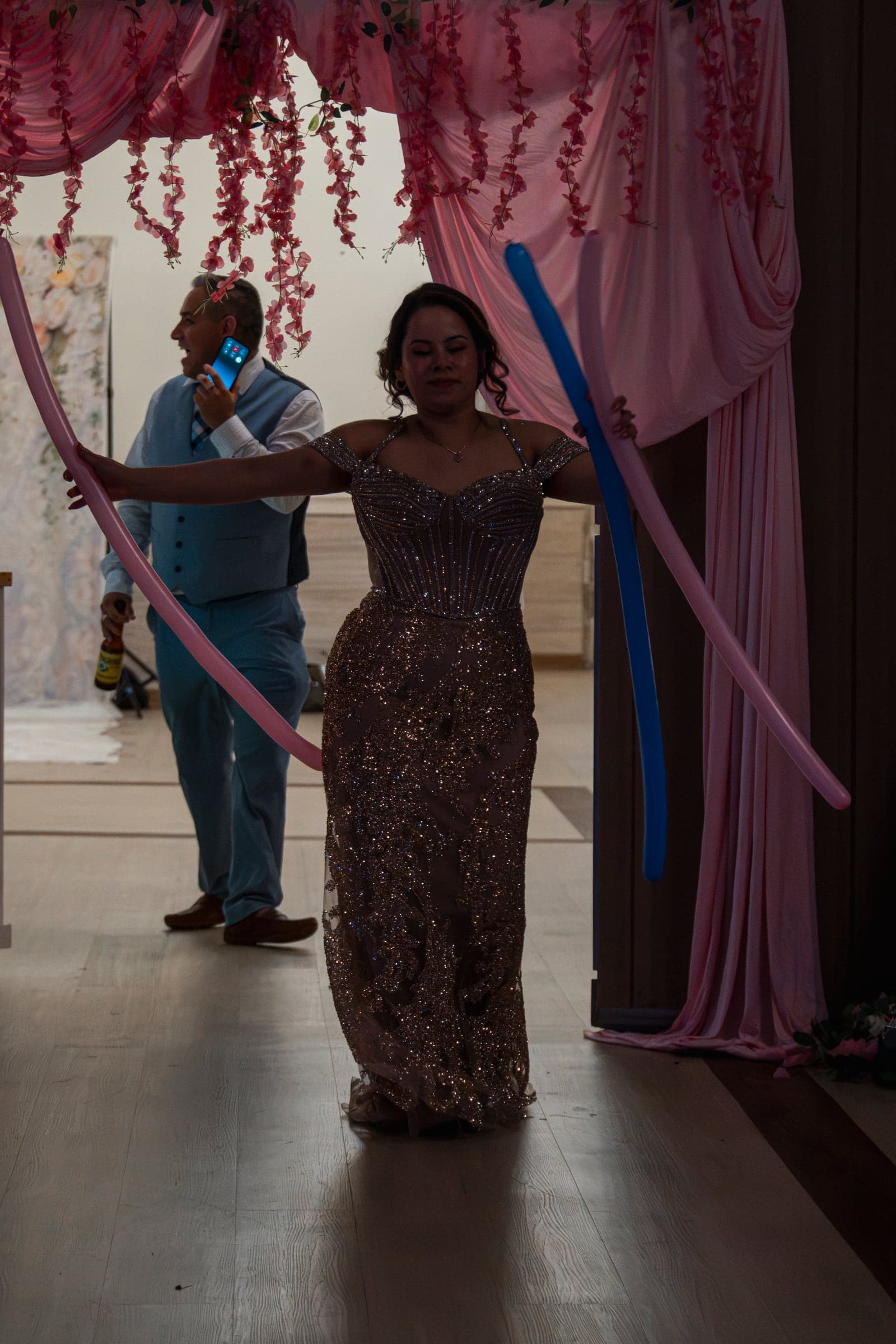 A guest making her entrance through an arch of balloons