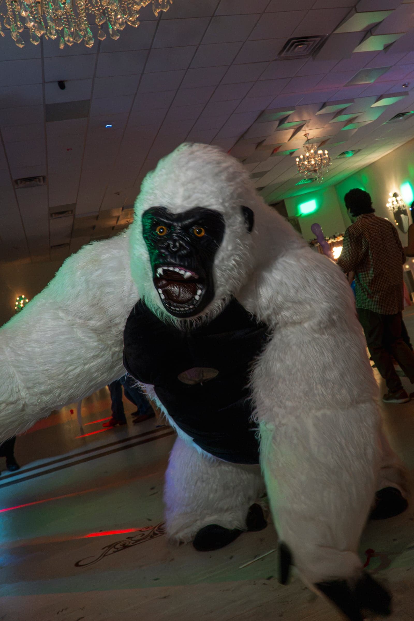 A costumed performer working the dance floor under coloured lights