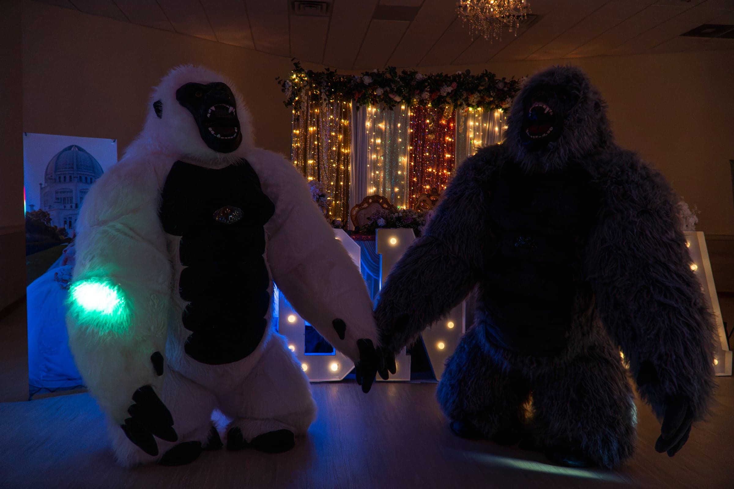 Two costumed performers entertaining guests on the dance floor