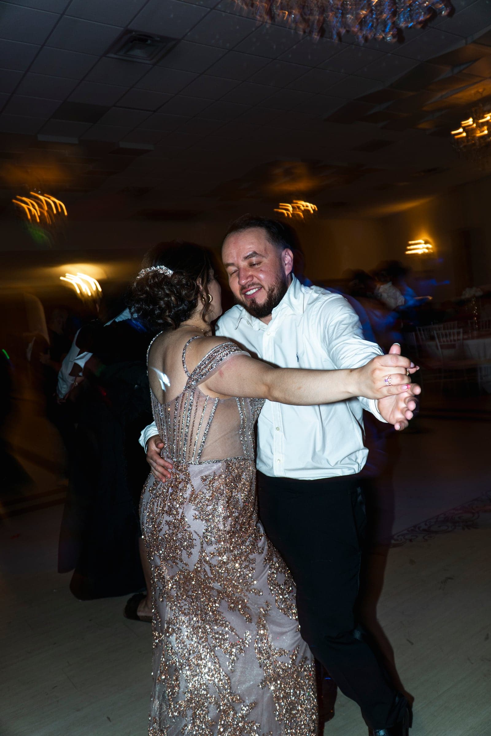 A slow dance on the floor, caught in a long exposure of moving light