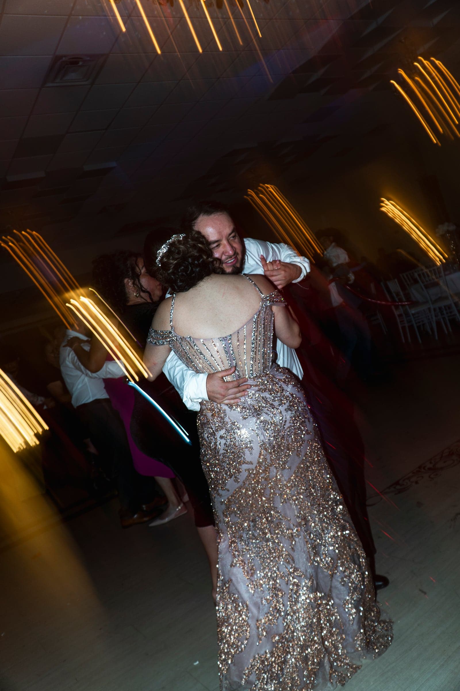 A slow dance under the lights, caught in a long exposure