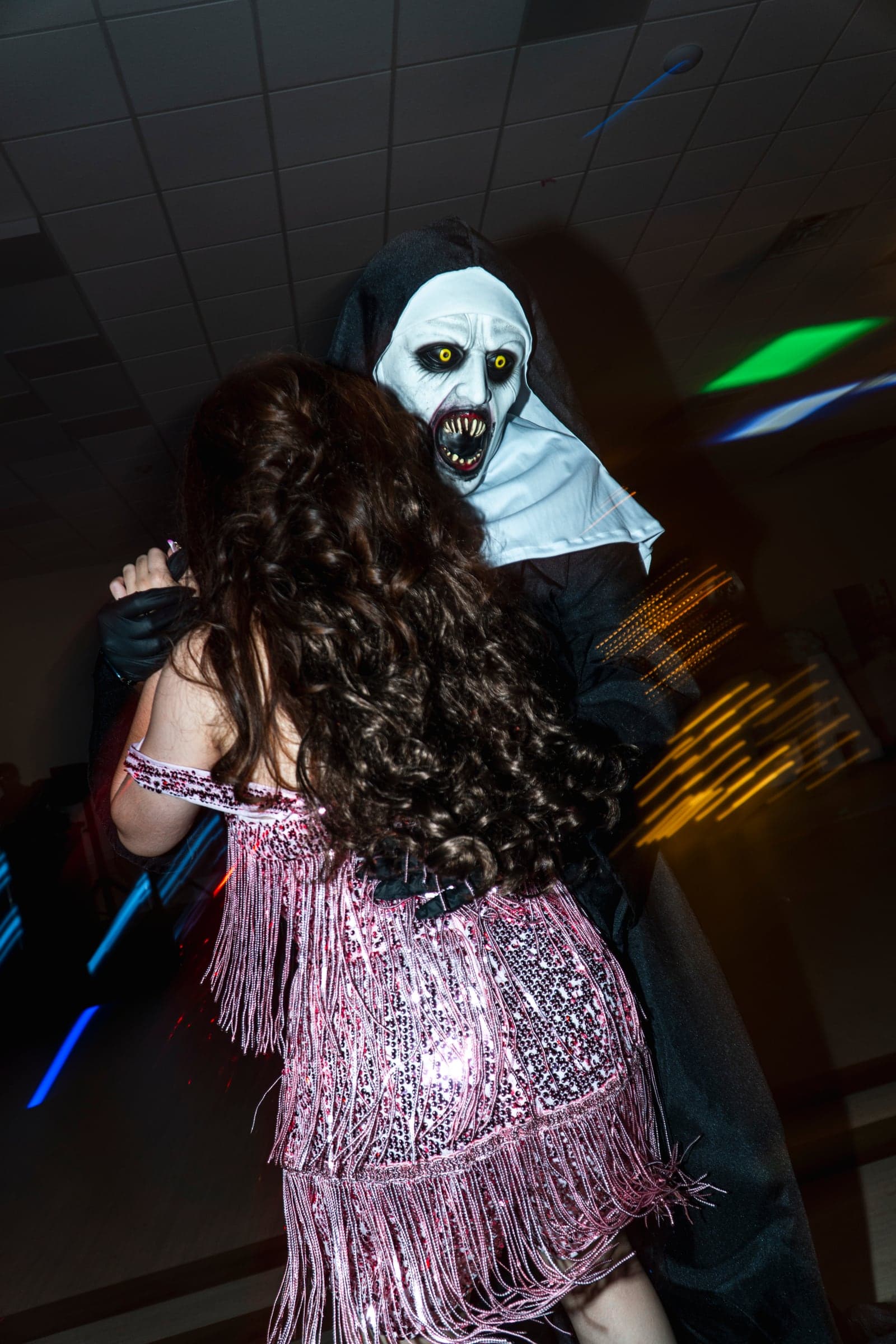 A guest spinning on the dance floor in a sequinned gown