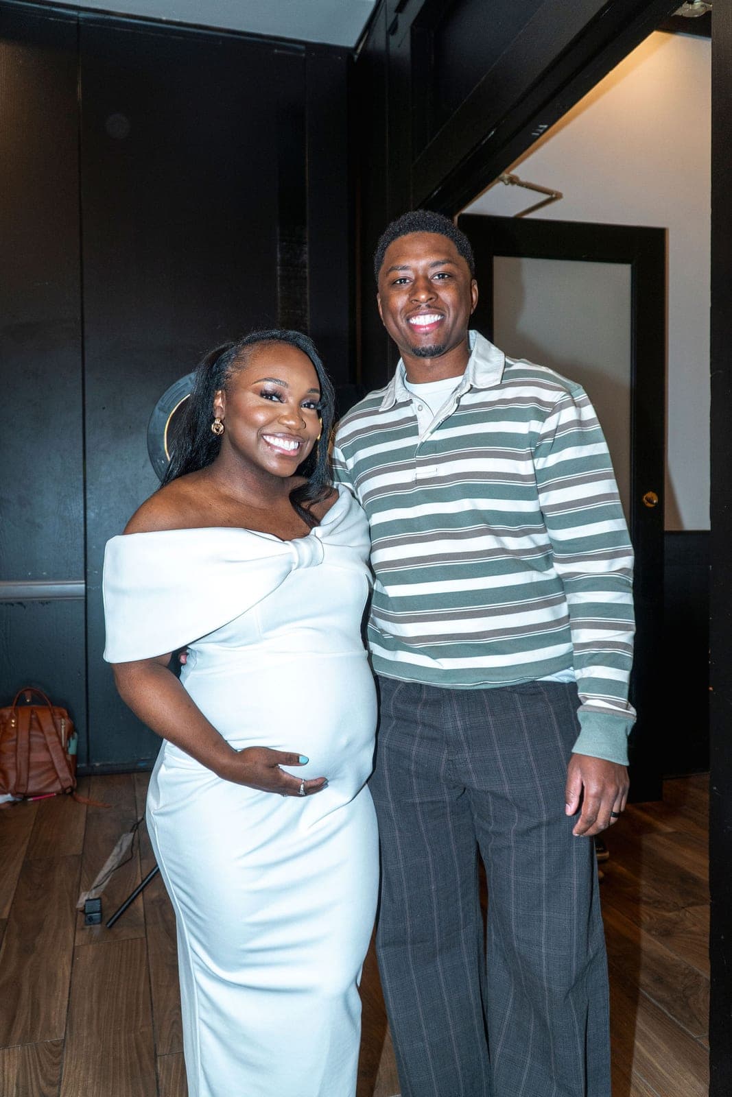An expectant couple standing together at their baby shower