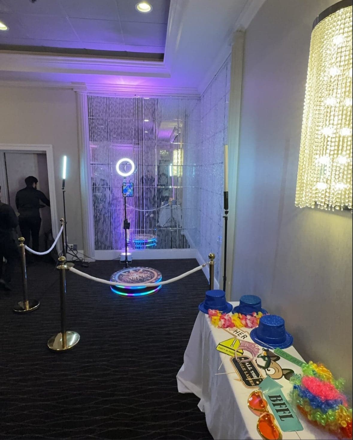 The 360 photo booth set up under chandeliers at an elegant venue