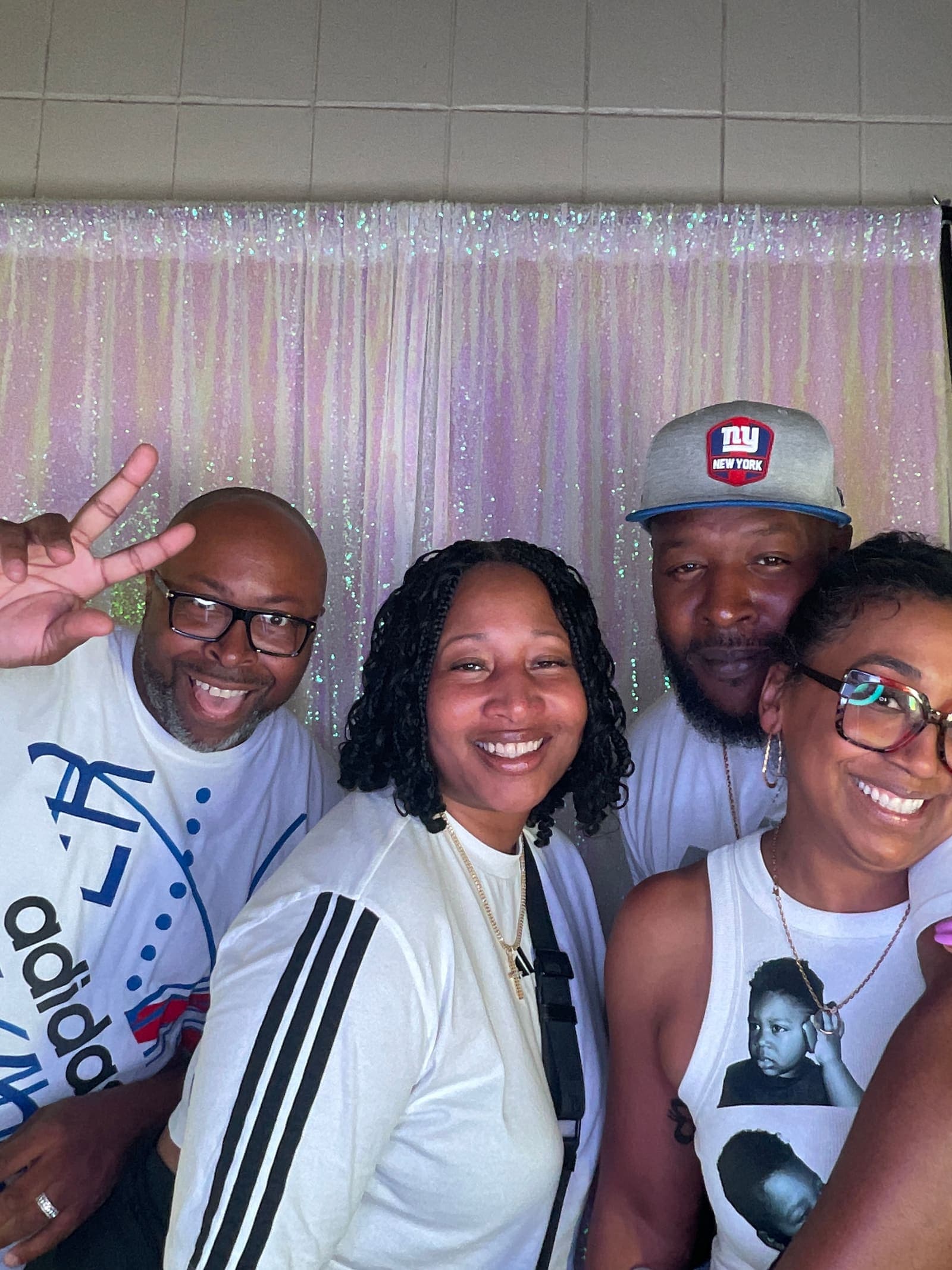 Graduate and family posing in the photo booth at a graduation party