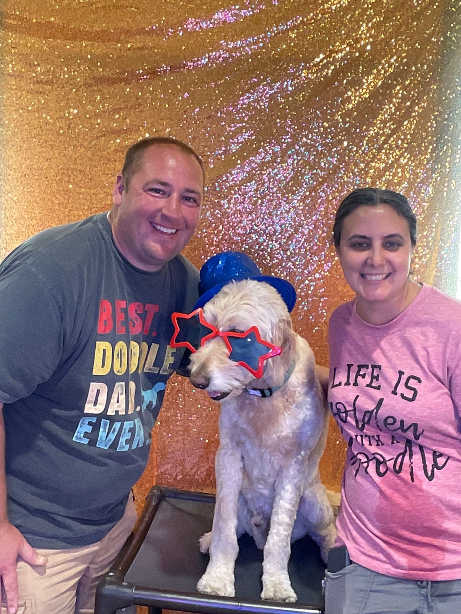 Guests and their dog posing together in the photo booth