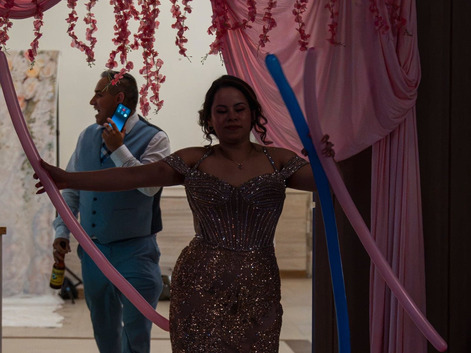 A guest making her entrance through an arch of balloons