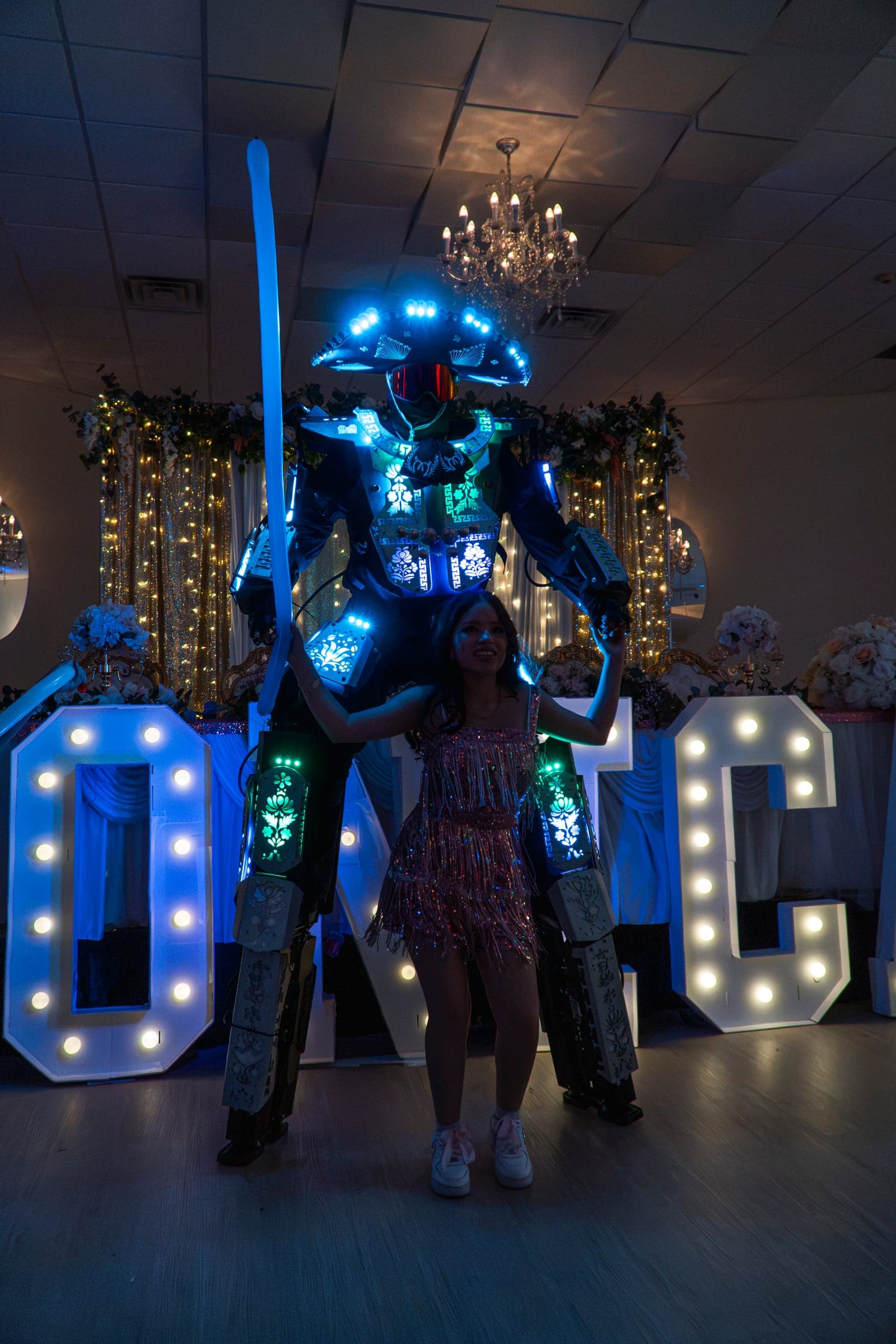 The guest of honour dancing with an LED performer beside her illuminated name