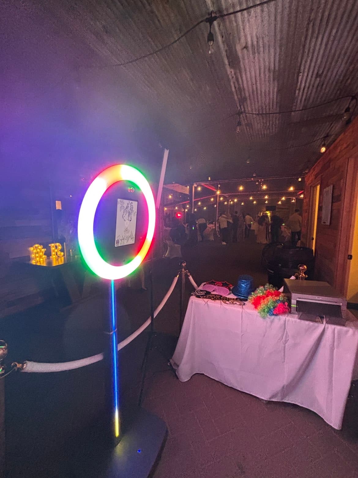The photo booth set up and glowing at a wedding reception